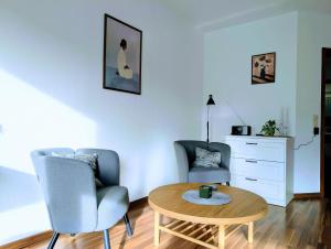 a living room with a table and two chairs at Apartment37671 in Höxter