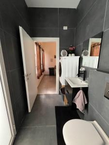 a bathroom with a white toilet and a sink at Up the Hill in Tiberias