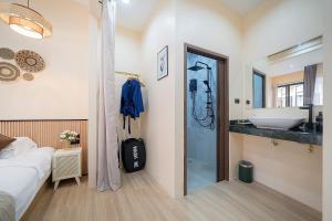 a bedroom with a bathroom with a sink and a shower at Amaleena Pool Access Suites in Ban Bang Chak