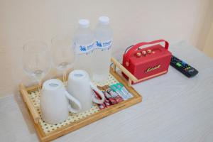 a tray with glasses and bottles of water on a table at Amaleena Pool Access Suites in Ban Bang Chak