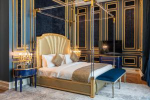 a bedroom with a canopy bed and a chair at The Bentley Luxury Hotel & Suites in Doha