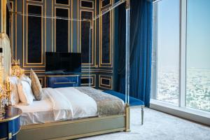 a bedroom with a bed with blue and gold walls at The Bentley Luxury Hotel & Suites in Doha