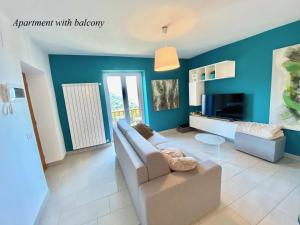 a living room with blue walls and a couch at Tower 44 in Luino