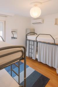 two bunk beds in a room with a rug at Hostel El Cascabel in Granada