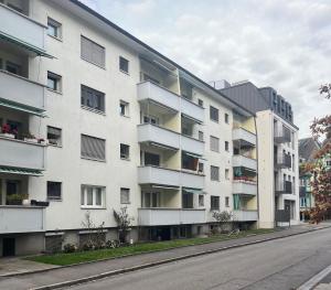 an apartment building on the side of a street at Perle Apartment in Interlaken