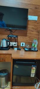 a desk with a microwave and a television on it at Pratima Heritage in Bhubaneshwar