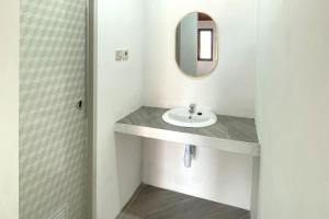 a bathroom with a sink and a mirror at Urbanview Hotel Nerine's Glamping Village Cipanas by RedDoorz in Barukupa