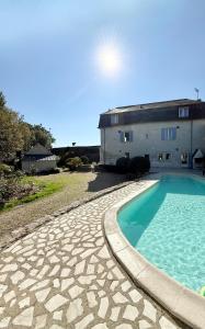 a swimming pool in front of a building at La Maison du Port Sauvage - Au bord de la Loire in Saint-Clément-des-Levées