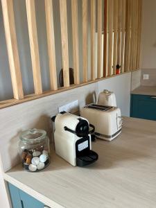 a kitchen counter with a toaster and a toaster and eggs at La Maison du Port Sauvage - Au bord de la Loire in Saint-Clément-des-Levées
