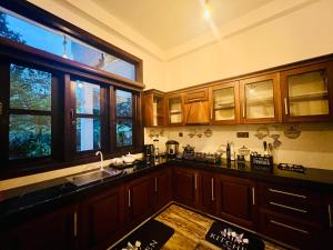 ディックウェラにあるMeadow View Villaのキッチン(木製キャビネット、シンク、窓付)