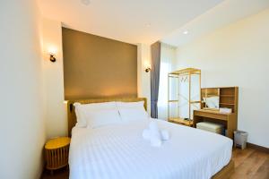 a bedroom with a large white bed with white pillows at Santara Pool Villa Udon in Udon Thani +37 photos