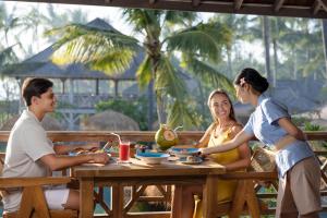 a group of people sitting at a table at Seven Dreams A Pramana Experience in Nusa Penida