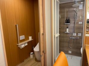 a bathroom with a shower and a toilet at Senoumi in Higashiizu