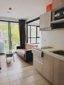 a kitchen and living room with a couch and a table at 02Nice room phuket town near Shopping Malls and Naka night market in Phuket Town