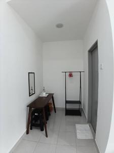 a white room with a desk and a basketball hoop at Raub Sutera Homestay in Kampong Sempalit Ulu