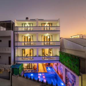 a building with a swimming pool in front of it at Eco Hotel Hoi An in Hoi An
