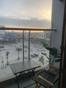 a balcony with a table and a view of a parking lot at X-Stay Sweet in An Khê