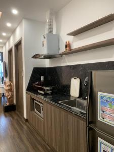 a kitchen with a sink and a counter top at X-Stay Sweet in An Khê