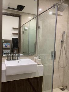 a bathroom with a white sink and a shower at X-Stay Sweet in An Khê +35 photos