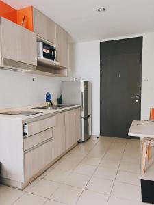 a kitchen with a refrigerator and a sink at 04near Shopping Malls and Naka night market in Phuket Town
