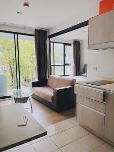 a living room with a couch and a bed at 04near Shopping Malls and Naka night market in Phuket Town