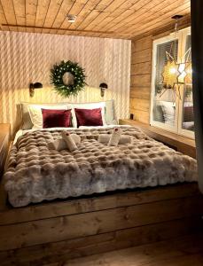 a bedroom with a large bed in a log cabin at Luxury City Cottage in Rovaniemi