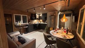 a kitchen with a table and chairs in a room at Luxury City Cottage in Rovaniemi