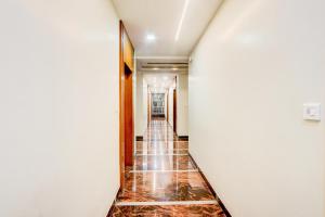 a hallway with a long corridor with tile floors at Hotel Narayan Villa in Rājahmundry