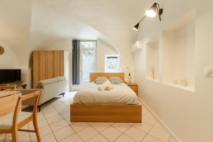 une chambre avec un lit, un bureau et une chaise dans l'établissement le cocon de Montélimar, à Montélimar