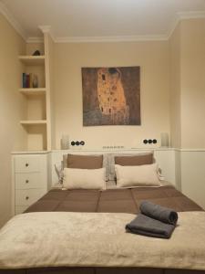 a bedroom with a bed with a guitar on the wall at Les Dos Nines in Monserrat