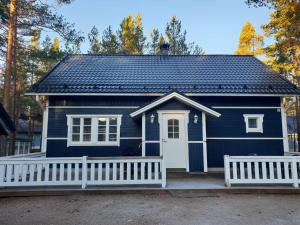 a blue tiny house with a porch at Aamuaurinko in Korospohja +8 photos