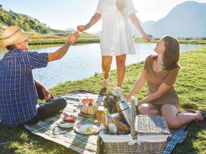 a group of people sitting on a picnic blanket at Studio Montagnard au Cœur du Grand-Bornand - Accès Bien-Être et Proximité Pistes - FR-1-467-30 in Le Grand-Bornand