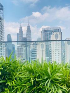 a view of the city from the balcony of a building at City centre Majestice Suite KLCC in Kuala Lumpur