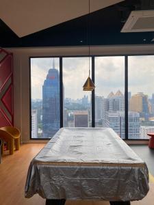 a large bed in a room with a large window at City centre Majestice Suite KLCC in Kuala Lumpur