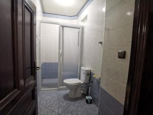 a bathroom with a toilet and a walk in shower at Appartement a Louer Laayoune in Laayoune
