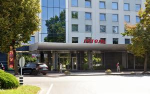 a building with a car parked in front of it at Hotel Mir in Rivne