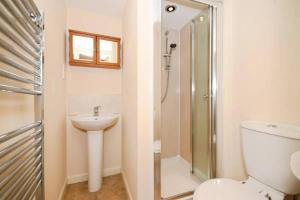 a bathroom with a toilet and a shower and a sink at Rock View Cottage in Stanton in Peak +14 photos