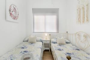 a bedroom with two beds and a window at La historia de la Casa de los Gatos in Los Narejos +22 photos