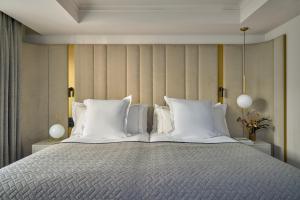 ein Schlafzimmer mit einem großen Bett und weißen Kissen in der Unterkunft MIM Andorra Member of Melia Collection in Escaldes-Engordany + 36 Fotos