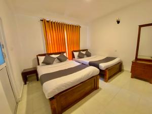 Ένα ή περισσότερα κρεβάτια σε δωμάτιο στο JETCO Lake Front Villa - Nuwara Eliya