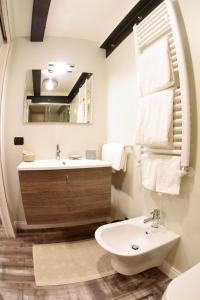 a white bathroom with a sink and a mirror at San Francesco Suite in Poggio Bustone