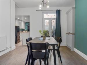 a kitchen and dining room with a table and chairs at Harrington Haven 4 Bed Contractor Friendly House with Parking Workington in Workington