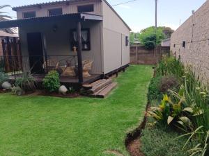a house with a yard with green grass at Log in At 118 Log 1 in Meyerton