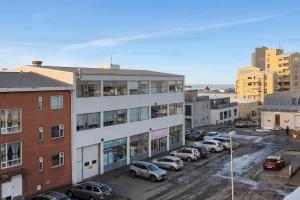 a city street with cars parked in a parking lot at Bright and Spacious Condo Downtown in Reykjavík