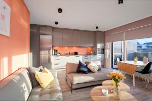 a living room with a couch and a table at Bright and Spacious Condo Downtown in Reykjavík