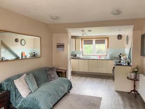 a living room with a couch and a kitchen at The Wee Pad - Uk42918 in Dunfermline