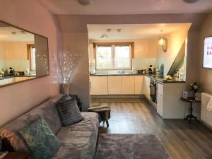 a living room with a couch and a kitchen at The Wee Pad - Uk42918 in Dunfermline