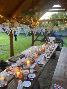 a long wooden table with candles and plates of food at U Eli I Tomka in Krzyżowa +43 photos