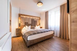 Postel nebo postele na pokoji v ubytování Hotel Hoferwirt