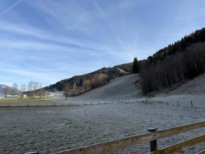 a large field with a fence and a hill at Kaprun 1 in Kaprun